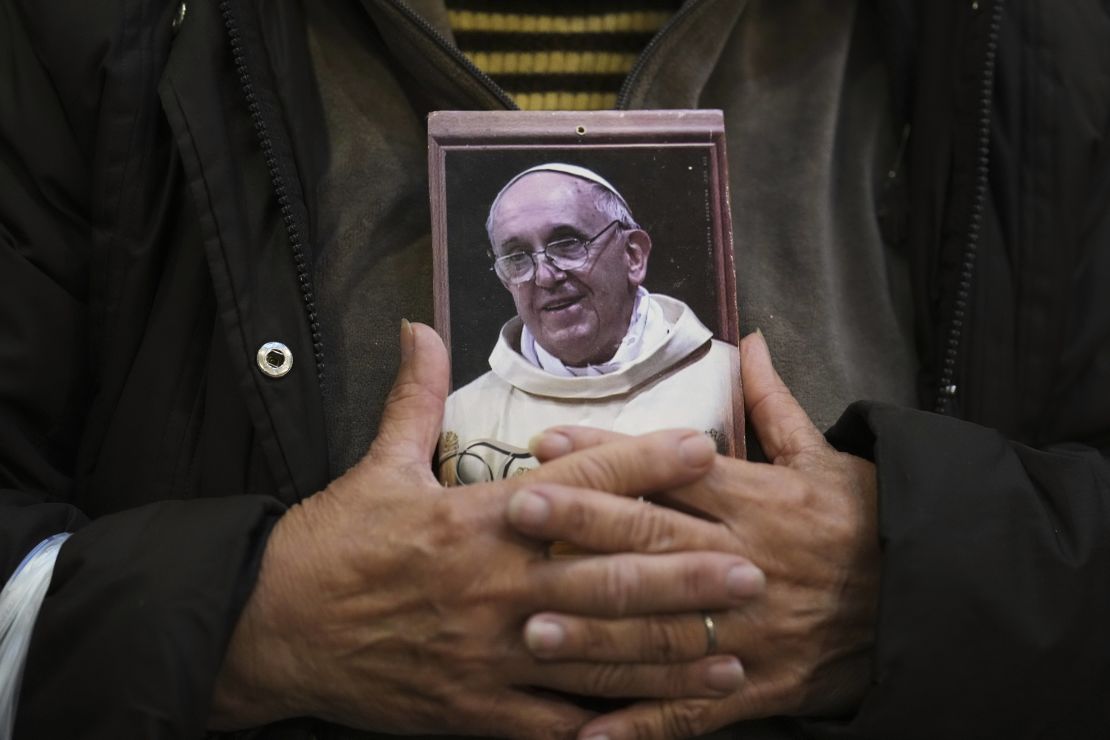 A mourner holds a portrait of Pope Francis in Buenos Aires, Argentina.