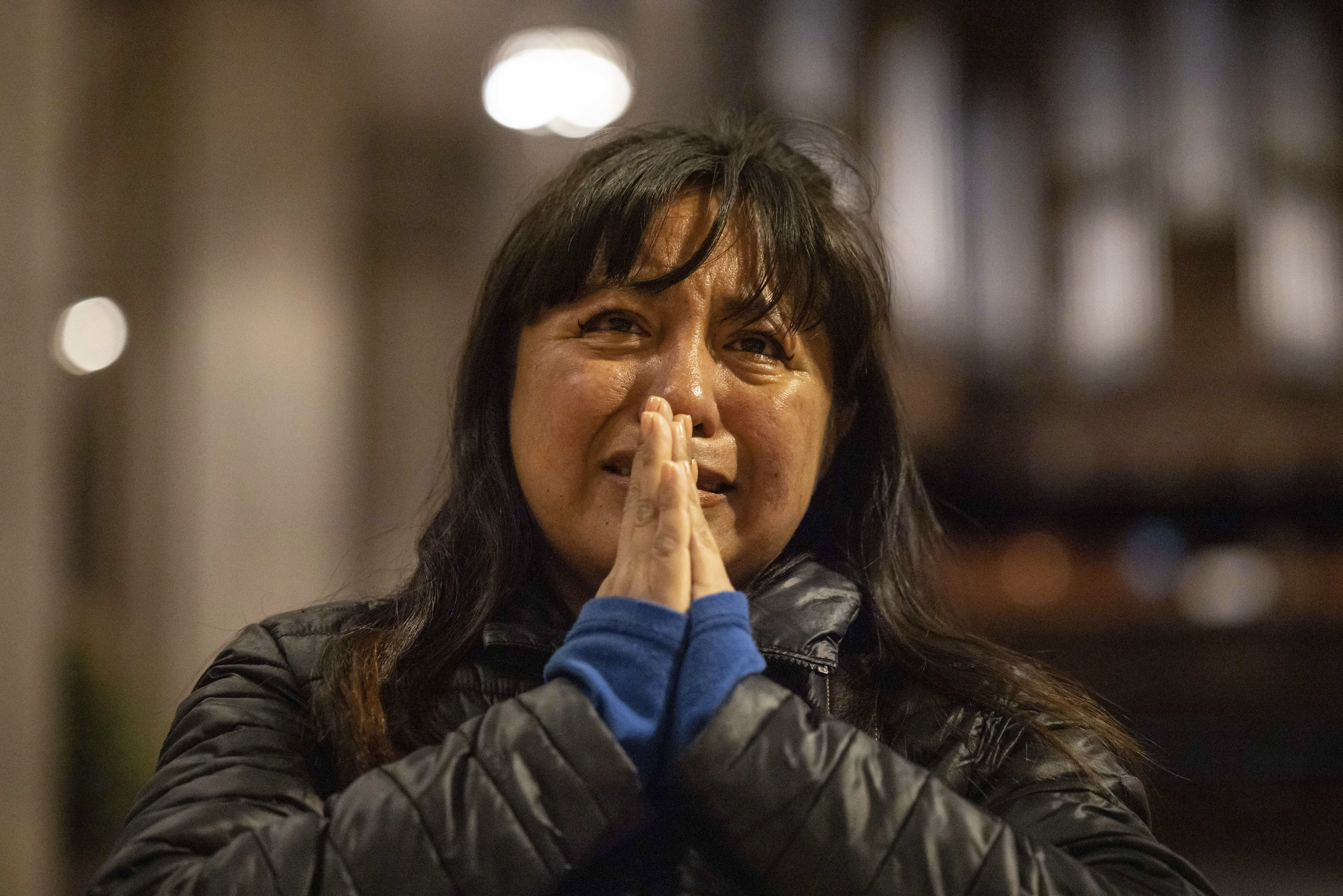A parishioner weeps in front of a picture of Pope Francis at St. Patrick's Cathedral in New York.