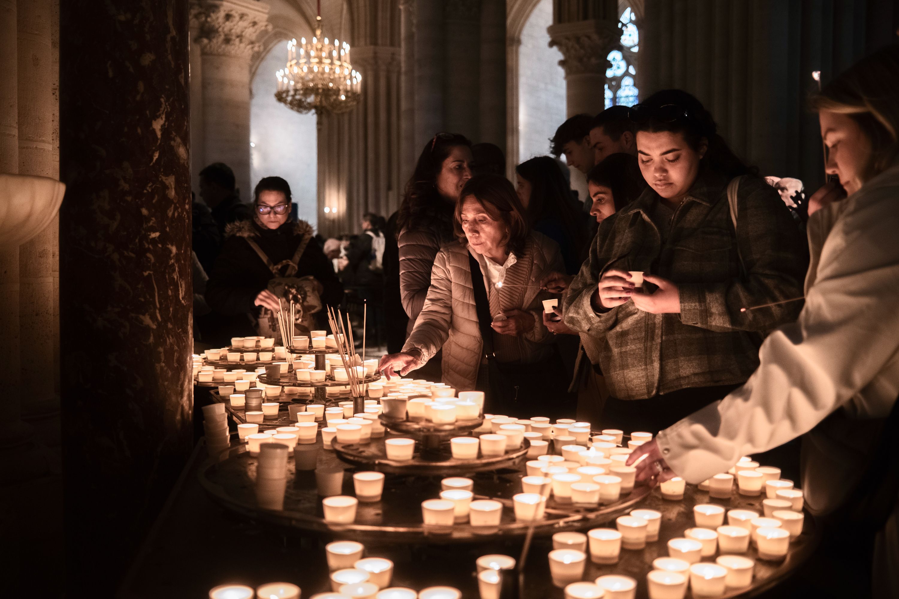 People light candles at the Notre Dame Cathedral in Paris on Monday, hours after the pope's death was announced.