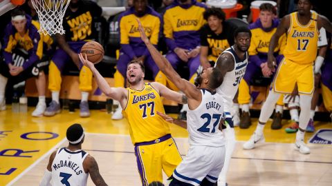 Los Angeles Lakers guard Luka Doncic goes to the basket against Minnesota Timberwolves center Rudy Gobert and forward Jaden McDaniels during the second half of Game 2 of an NBA basketball first-round playoff in Los Angeles, Tuesday, April 22, 2025.