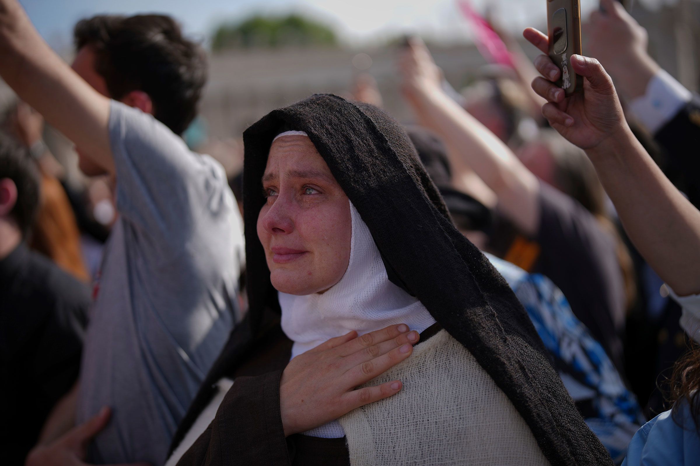 A nun cries as the body of Pope Francis is carried into St. Peter's Basilica.
