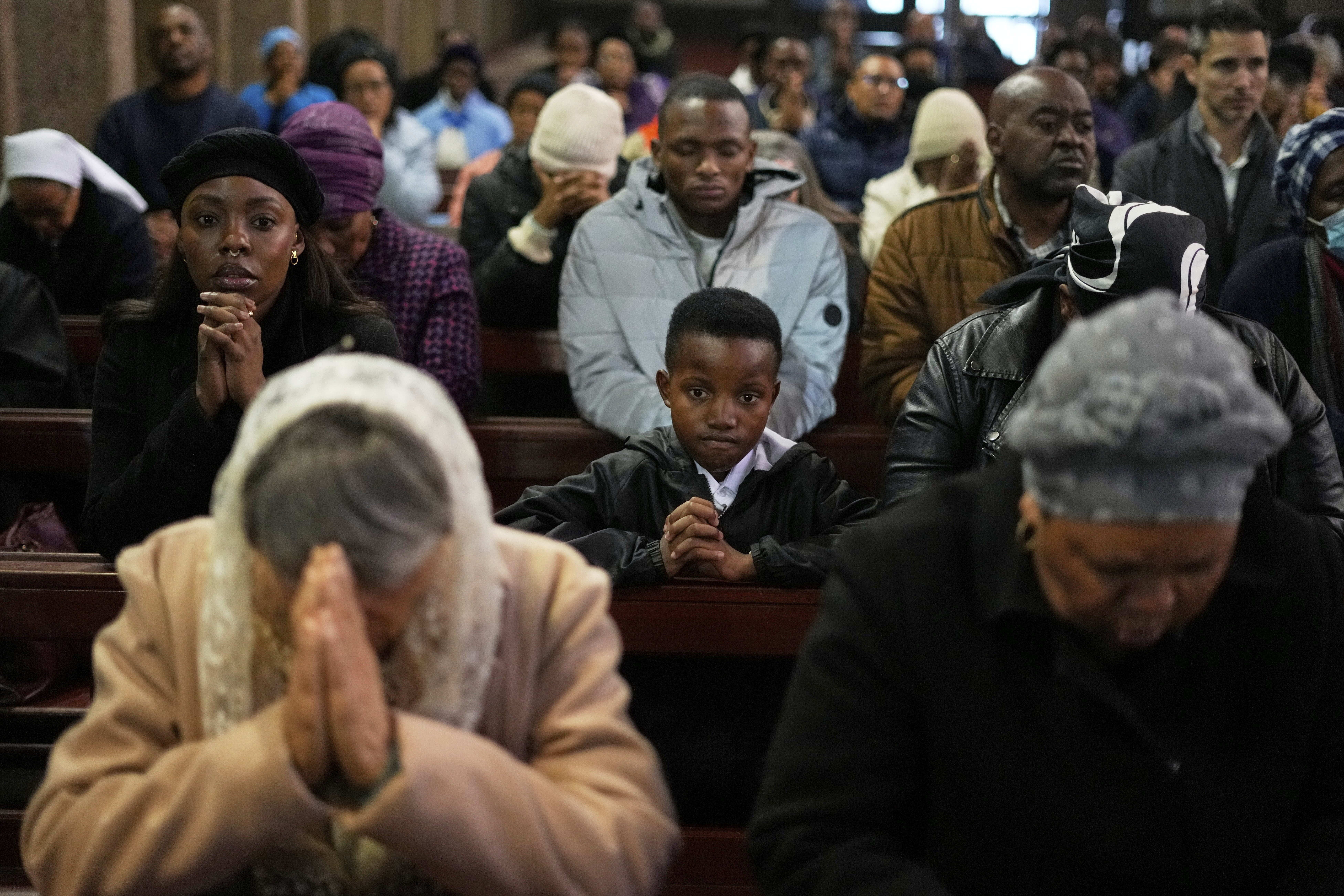 People in Johannesburg pray during a memorial Mass at the Cathedral of Christ the King.