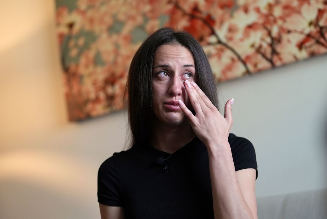Oksana Tarasiuk wipes away tears as she talks about her husband, Maksym Chernyak, at the couple's apartment in Hallandale Beach, Florida.