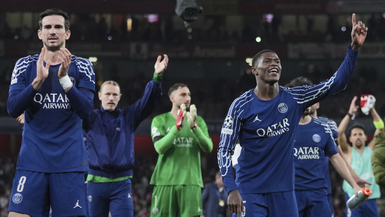 PSG's Fabian Ruiz, left, and Nuno Mendes celebrate with their fans at the end of the Champions League semifinal first leg soccer match between Arsenal and Paris Saint-Germain at Arsenal Stadium in London, England, Tuesday, April 29, 2025. (AP Photo/Kin Cheung)