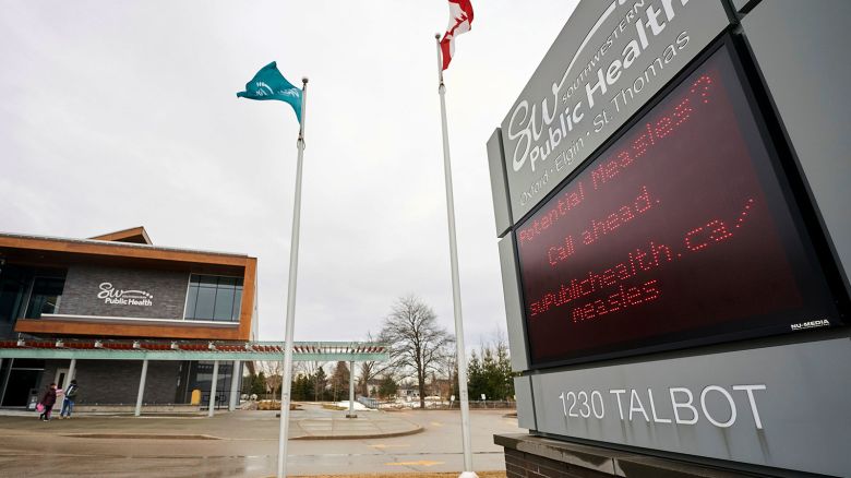 A sign outside Southwestern Public Health in St. Thomas, Ontario, Canada, on Tuesday, March 4, 2025, warns residents to call ahead before visiting a doctor or hospital if they think they have the measles. (Geoff Robins/The Canadian Press via AP)