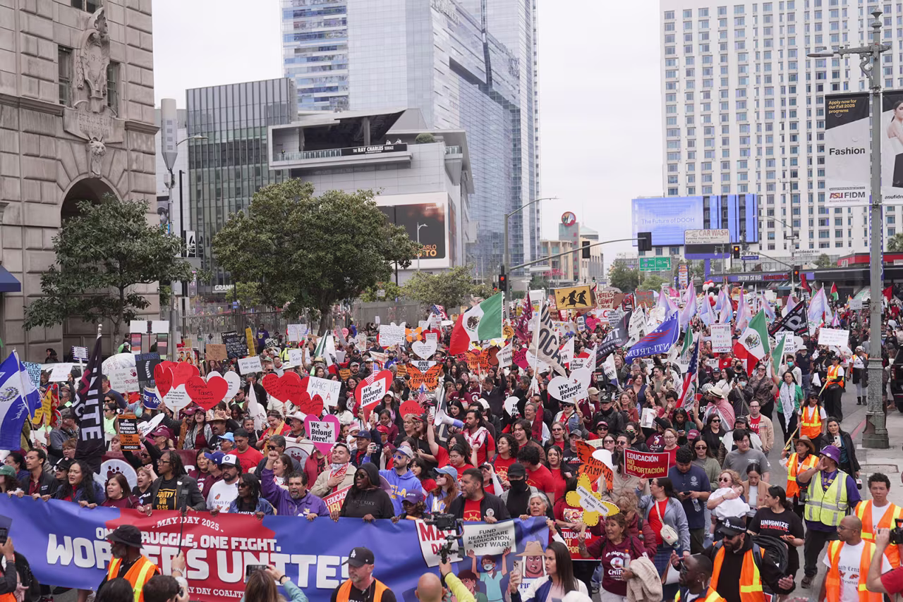 Demonstrators march during a May Day protest in Los Angeles, on Thursday.