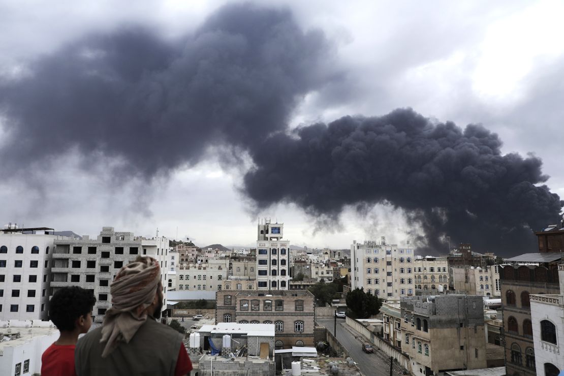 Yemenis will be seen following a strike in Yemen's capital on Tuesday.