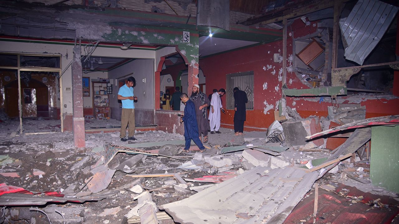 Local residents and members of the media examine a building damaged by a suspected Indian missile attack near Muzaffarabad, the capital of Pakistan controlled Kashmir, in Wednesday, May 7, 2025. (AP Photo/M.D. Mughal)