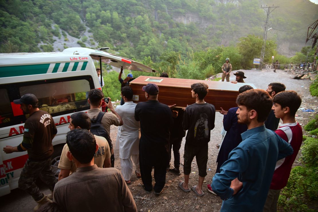 Volunteers load a body into an ambulance after recovering it from a mosque damaged by an Indian missile strike near Muzaffarabad, in Pakistan-administered Kashmir, on May 7, 2025.