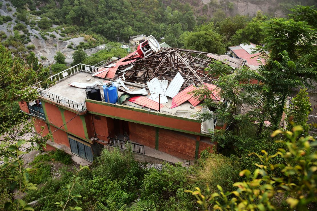 An army soldier stands guard on the rooftop of a mosque building damaged by a suspected Indian missile attack near Muzaffarabad, the capital of Pakistan-administered Kashmir, on Wednesday, May 7, 2025.