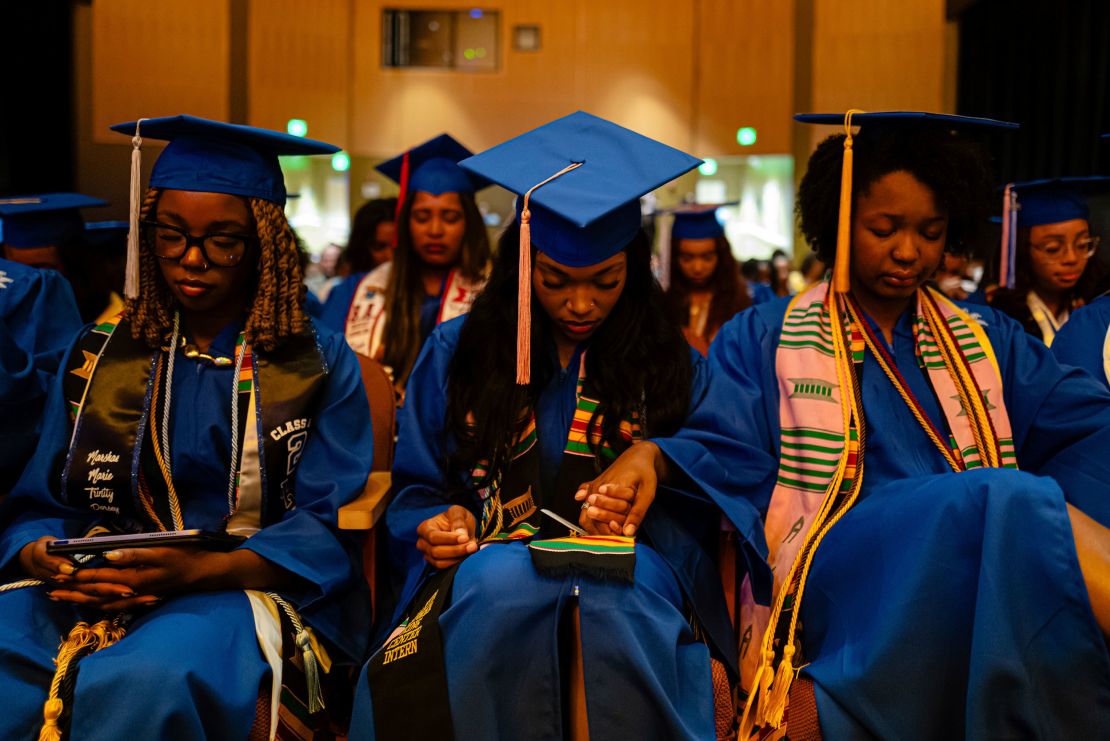 Graduates pray during the Senior Salute at Lyric Theatre in Lexington, Kentucky, on May 7, 2025.