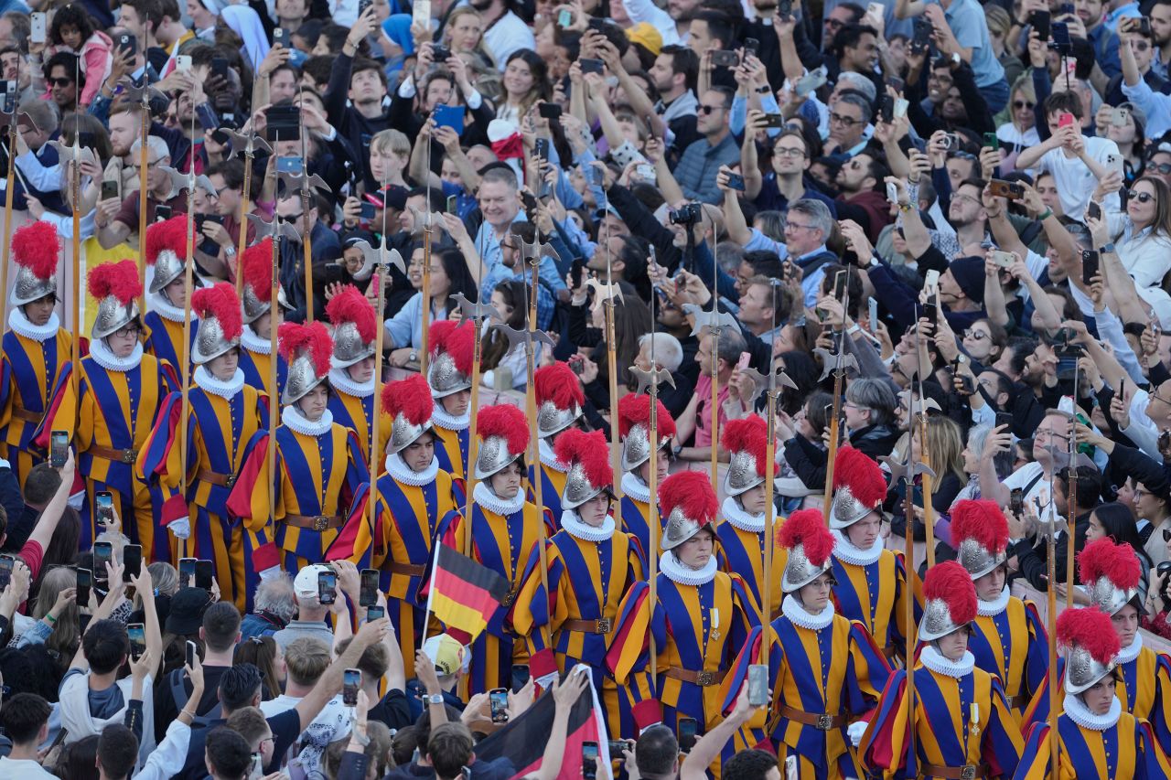 The Swiss Guard marches through the crowd in St. Peter's Square after white smoke billowed from the chimney of the Sistine Chapel.