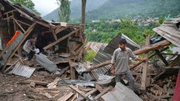 People inspect their damaged shops following overnight shelling from Pakistan at Gingal village in Uri district, north of Srinagar in Indian controlled Kashmir, Friday, May 9, 2025. (AP Photo/Dar Yasin)