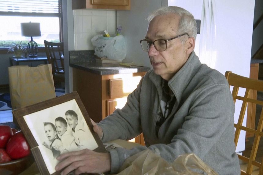 John Prevost points to a childhood photo of his brothers. The newly elected Pope Leo XIV is at the left of the photo.