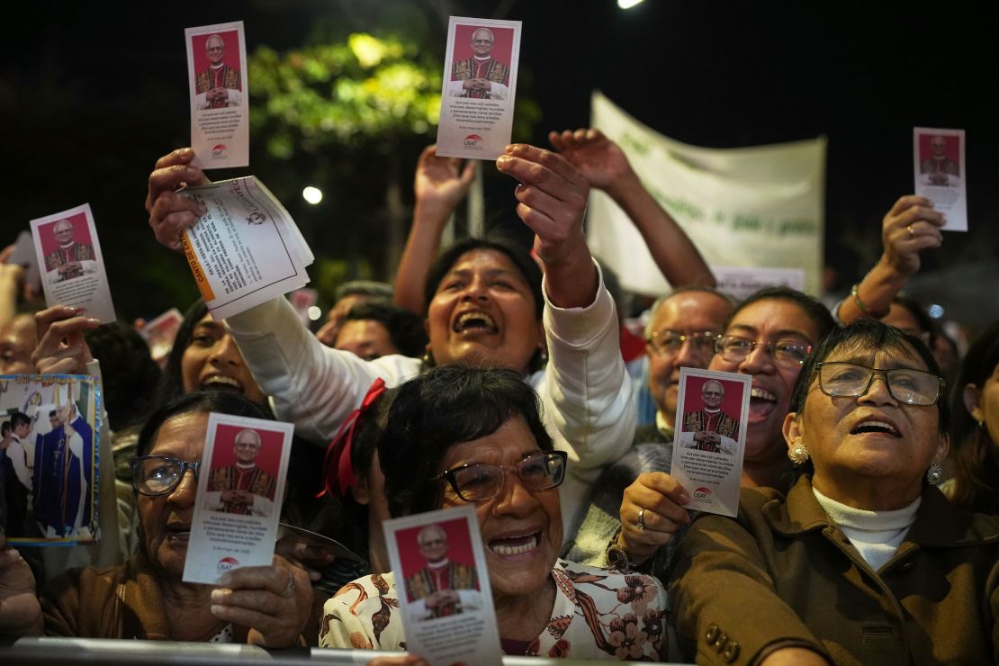 People celebrate by waving flyers of newly-elected Pope Leo XIV during a Mass in his honor in Chiclayo, Peru, on Saturday.
