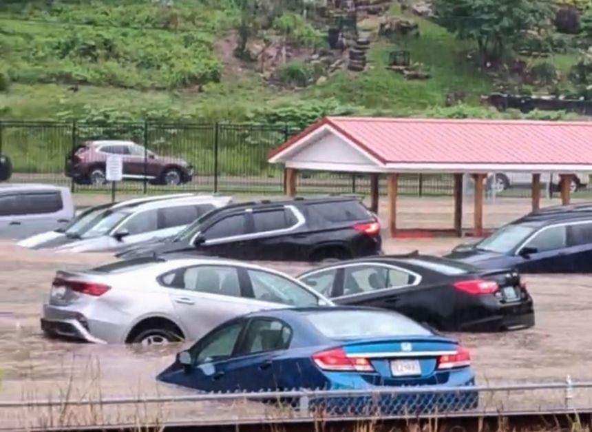 Cars are submerged in a parking lot of Westernport Elementary School as flooding forces the evacuation of the school, and downtown homes and businesses were inundated with rising floodwaters in rural Westernport, Md., Tuesday, May 13, 2025.
