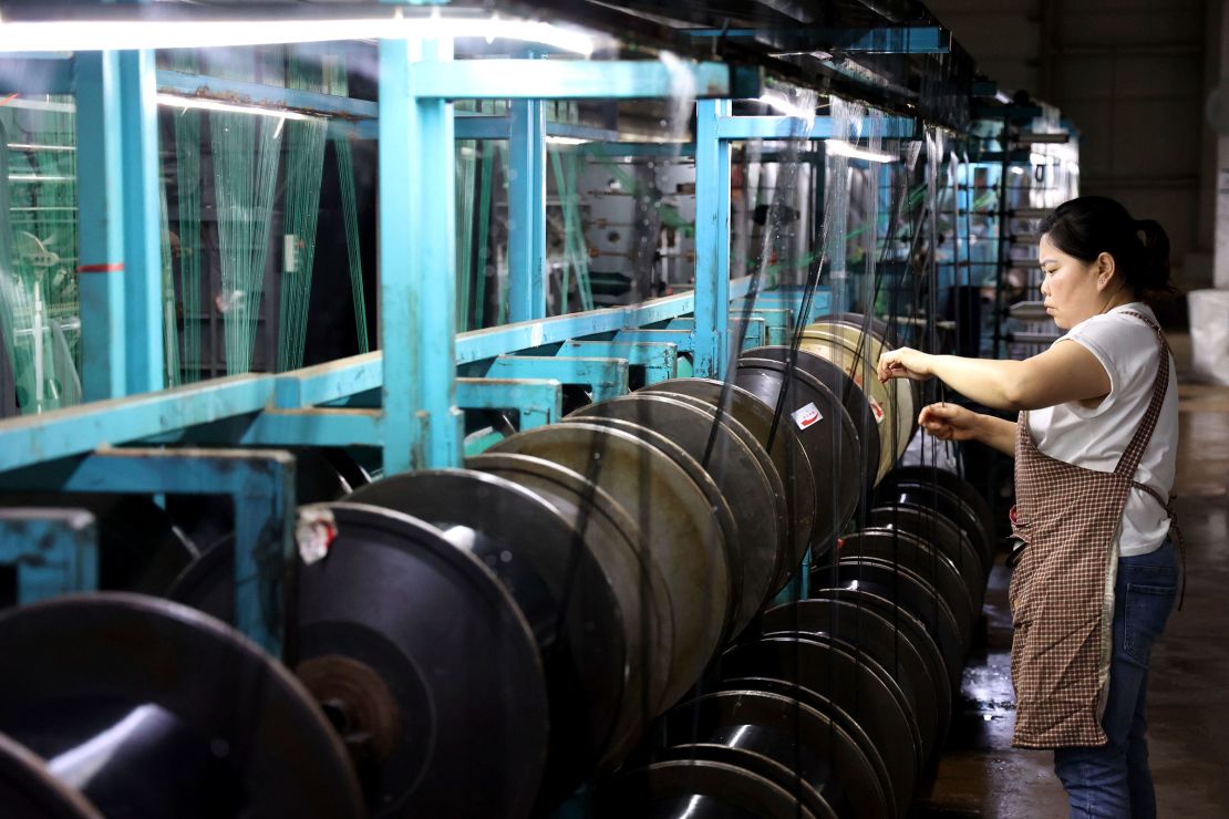 A woman works in a factory weaving nets in China's Shandong province on Wednesday.