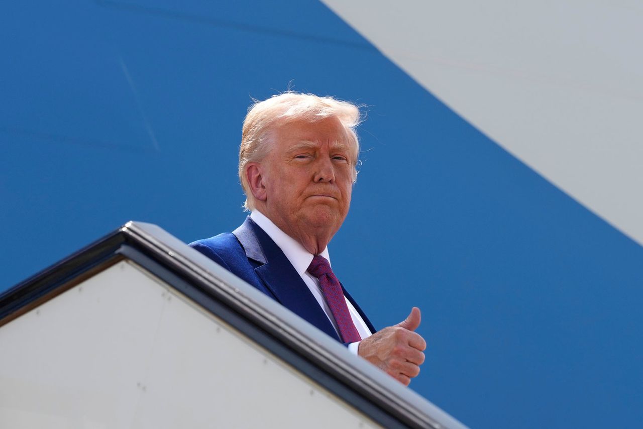 President Donald Trump gives a thumbs up as he boards Air Force One to depart Al Udeid Air Base in Doha, Qatar, on Thursday.