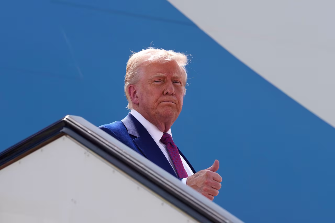 President Donald Trump gestures as he boards Air Force One to depart Al Udeid Air Base on Thursday, in Doha, Qatar.