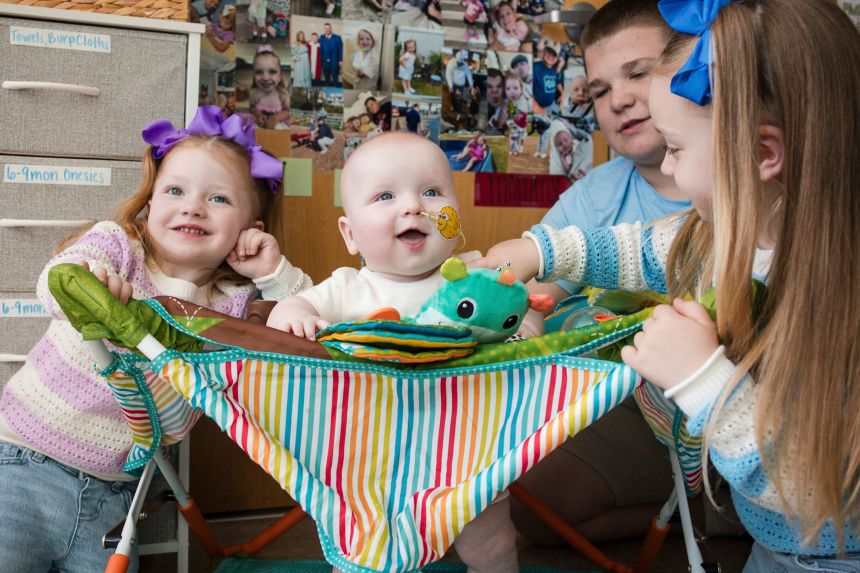 KJ Muldoon, center, sits with his siblings after a follow-up dose of an experimental gene-editing treatment in April. (Chloe Dawson/Children's Hospital of Philadelphia via AP)