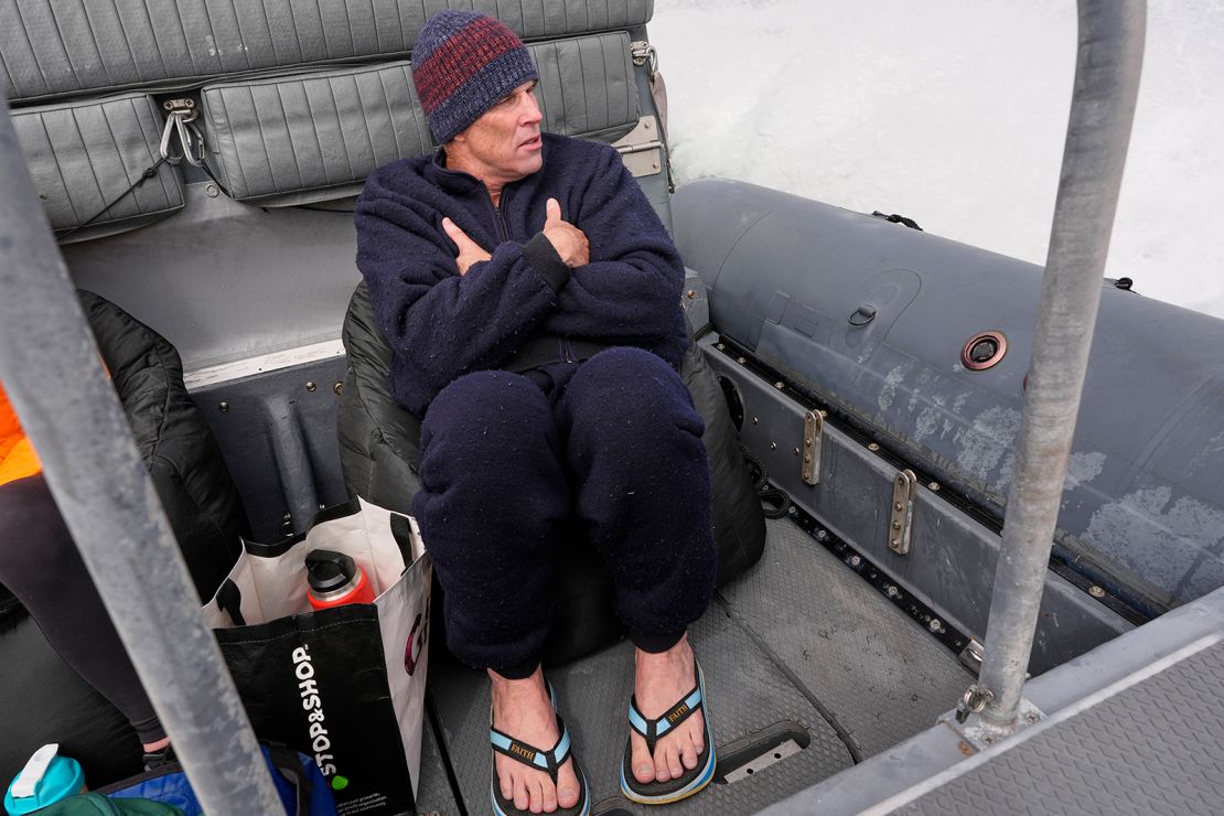 Endurance swimmer Lewis Pugh warms up on the ride back to shore after completing the first leg of his swim around Martha's Vineyard, Thursday, May 15, 2025, off Edgartown, Mass.
