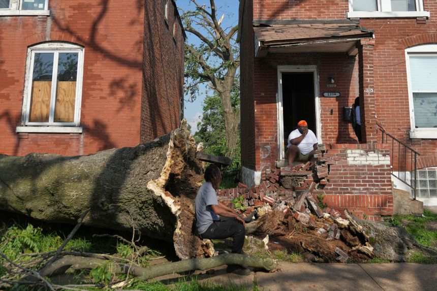 People survey damage after a severe storm moved through Friday, May 16, 2025, in St. Louis.