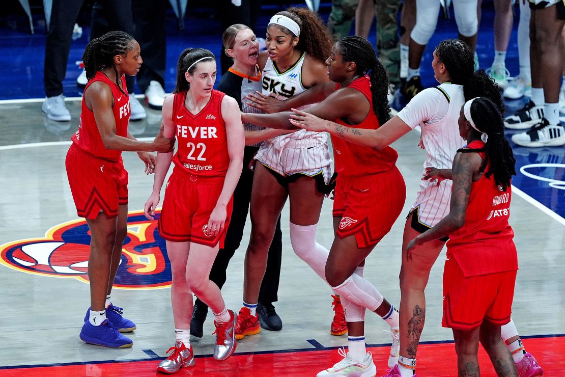 Chicago Sky forward Angel Reese reacts after being fouled by Indiana Fever guard Caitlin Clark, as Fever forward Aliyah Boston tries to separate Reese from Clark on May 17.