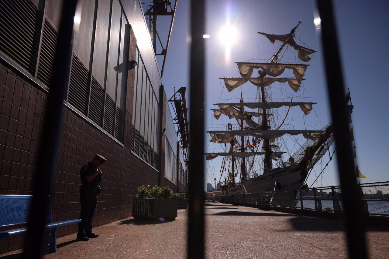 A police officer stands watch where the Cuauhtémoc sits docked on Sunday.