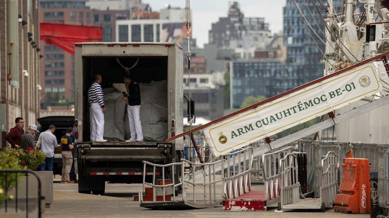 Crew members and personnel of the National Transportation Safety Board walk near the Cuauhtemoc, a masted Mexican Navy training ship, at Pier 35 after it collided with the Brooklyn Bridge, on Sunday, May 18, 2025, in New York.