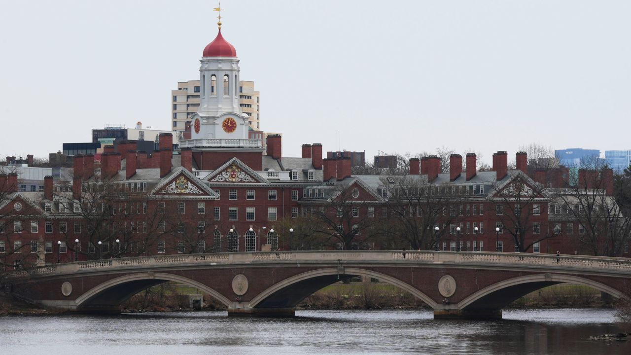 FILE - A sculler rows down the Charles River near Harvard University, at rear, April 15, 2025, in Cambridge, Mass. (AP Photo/Charles Krupa, File)