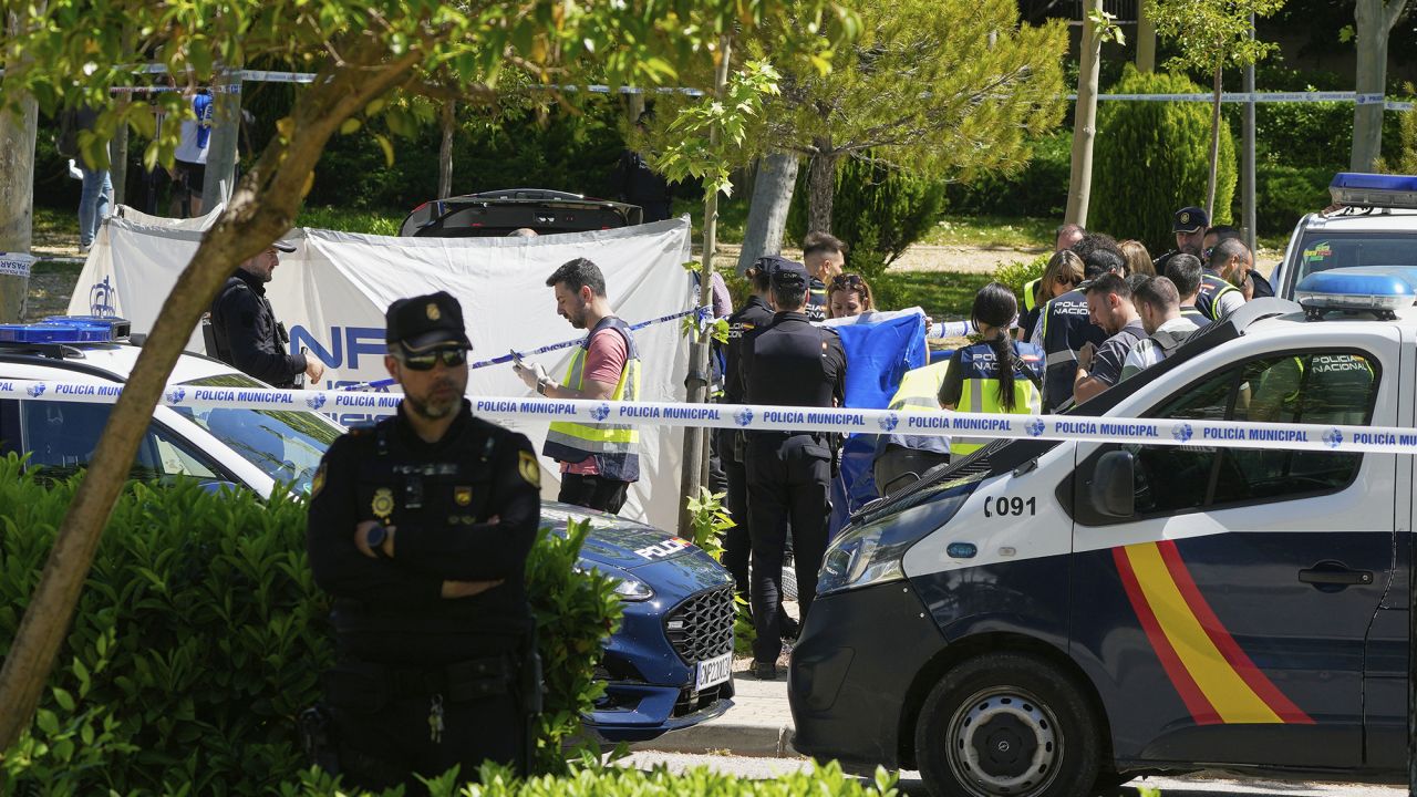 Members of the judicial police at the scene after an adviser to former Ukrainian president Viktor Yanukovych was shot, outside a school in Madrid, Spain, Wednesday, May 21, 2025. (AP Photo/Paul White)