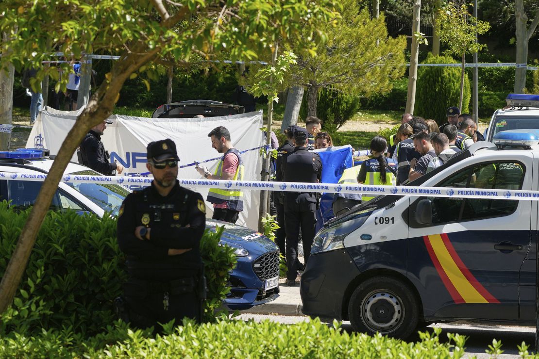 Members of the judicial police at the scene outside The American School in Madrid after Andriy Portnov was shot dead on Wednesday.