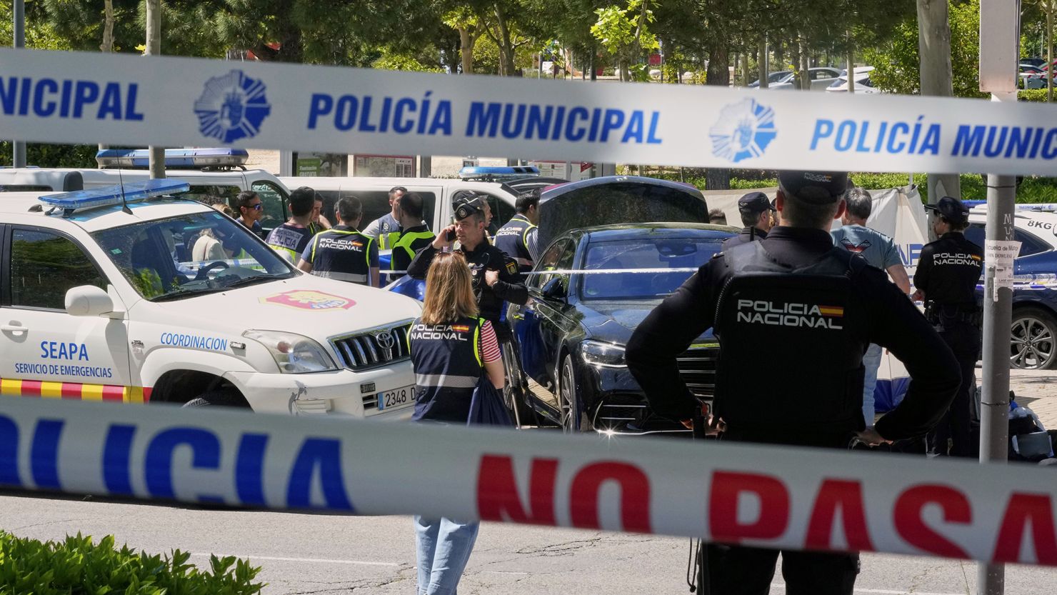 Police officers cordon off the area outside The American School of Madrid shortly after the former senior aide to ex-Ukrainian president Viktor Yanukovych was shot.