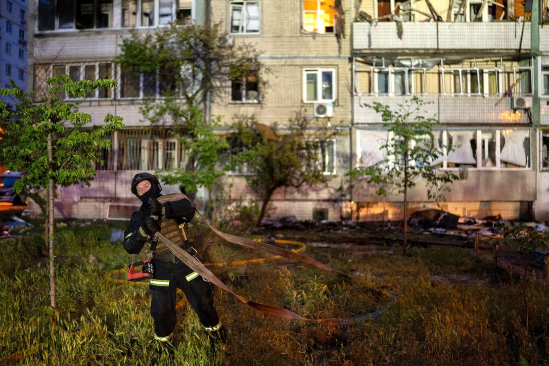 A firefighter works on the site of a residential building damaged in the attack.