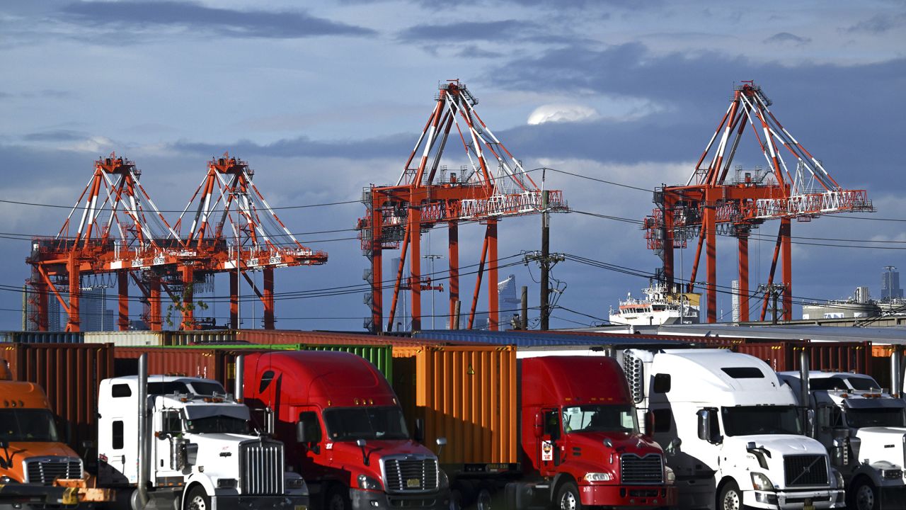 View of shipping cranes seen behind trucks and shipping containers at a port in Elizabeth, NJ, on May 24.