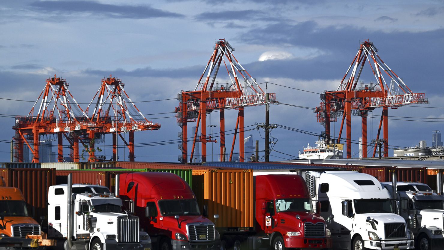 View of shipping cranes seen behind trucks and shipping containers at a port in Elizabeth, NJ, on May 24.