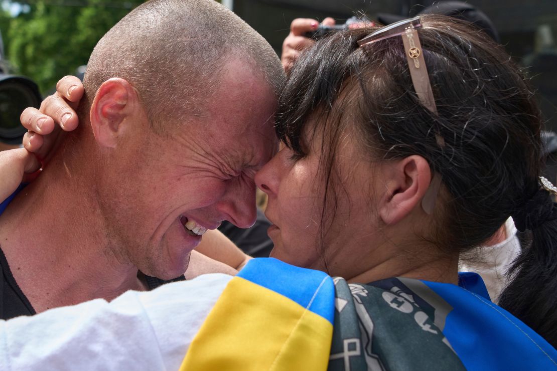 A Ukrainian serviceman hugs his wife after returning from captivity during a prisoner exchange between Russia and Ukraine Sunday, May 25, 2025