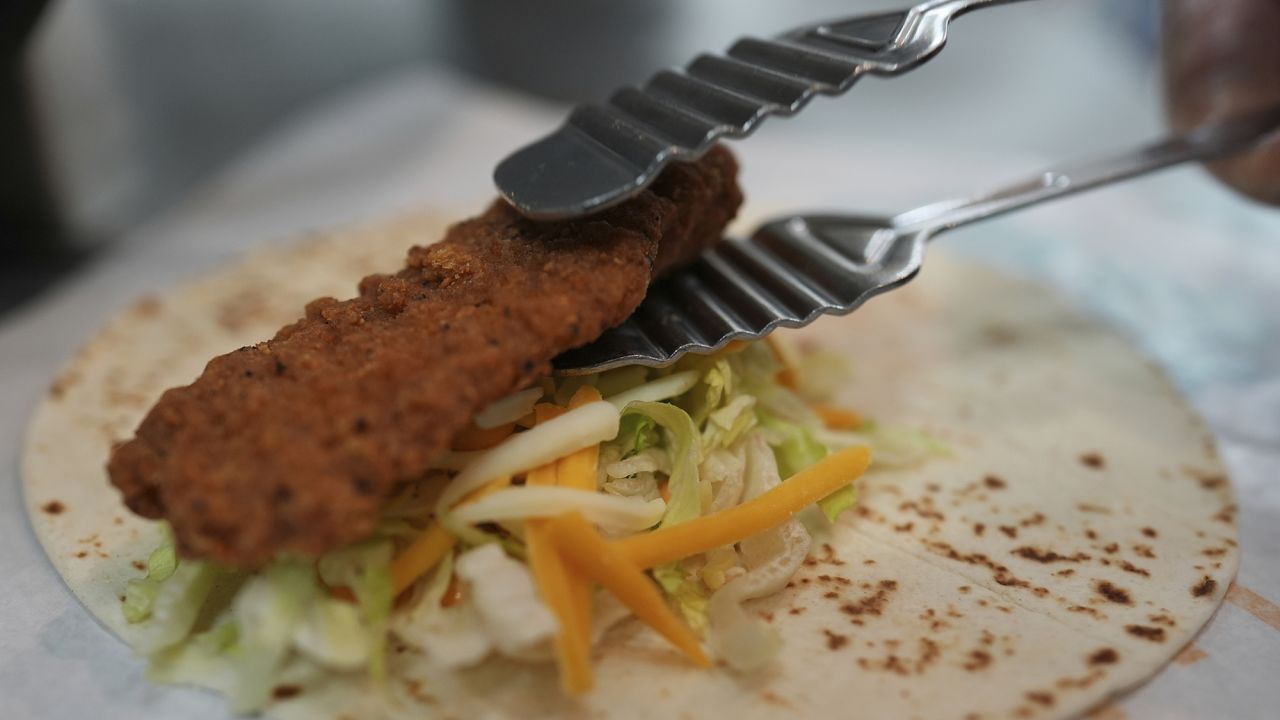 Charles L. Krumsiek, a McDonald's chef, puts a chicken on a tortilla to make a snack wrap at McDonald's Headquarter in Chicago, Thursday, May 29, 2025.