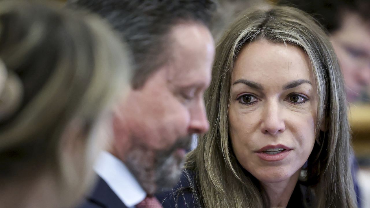 Karen Read speaks with her attorney Alan Jackson during her murder trial in Norfolk Superior Court in Dedham, Massachusetts on Friday, May 30, 2025.