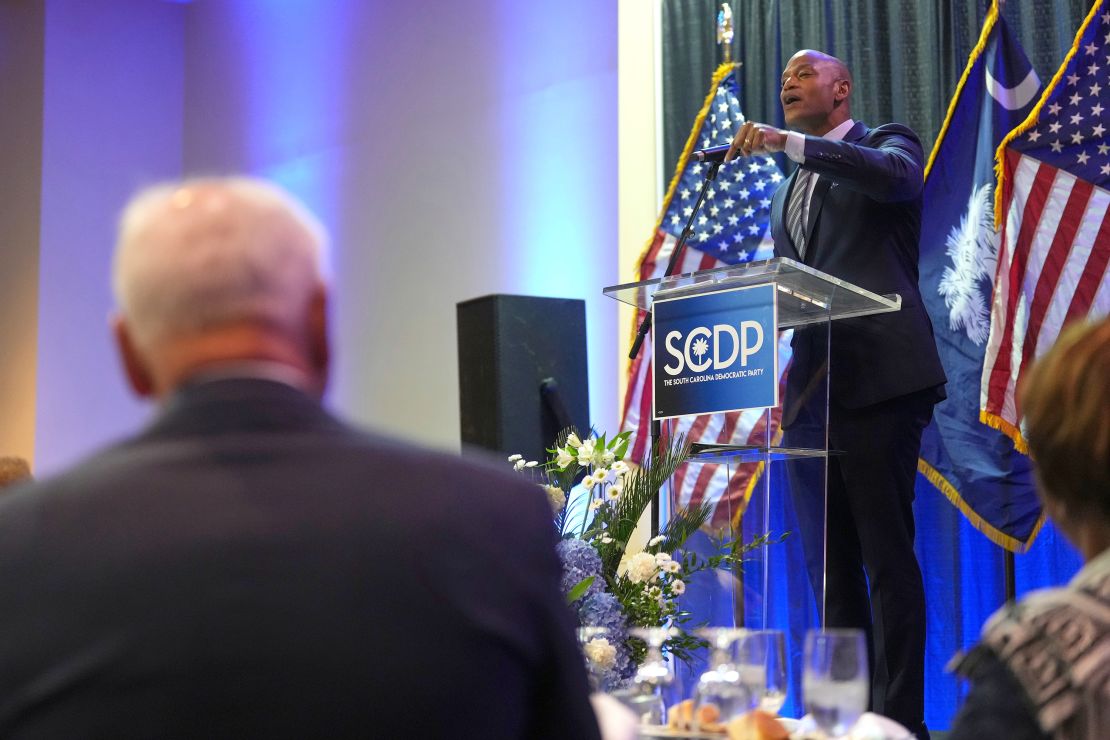 Moore, right, speaks at the South Carolina Democratic Party's Blue Palmetto Dinner as Walz listens.