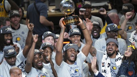 Indiana Pacers center Myles Turner holds the trophy as players celebrate after winning Game 6 of the Eastern Conference finals of the NBA basketball playoffs against the New York Knicks in Indianapolis, Saturday, May 31, 2025. (AP Photo/AJ Mast)