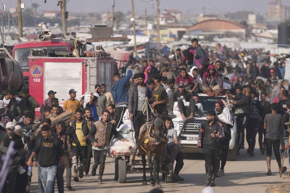 Palestinians carry food packages from the US and Israeli-backed Gaza Humanitarian Foundation, in Khan Younis, southern Gaza, on June 1.