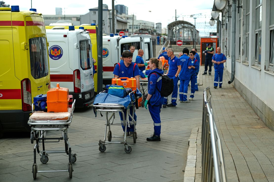Medics wait for the arrival of wounded passengers after a bridge collapsed onto a train in Russia's Bryansk region, in this picture released Sunday.