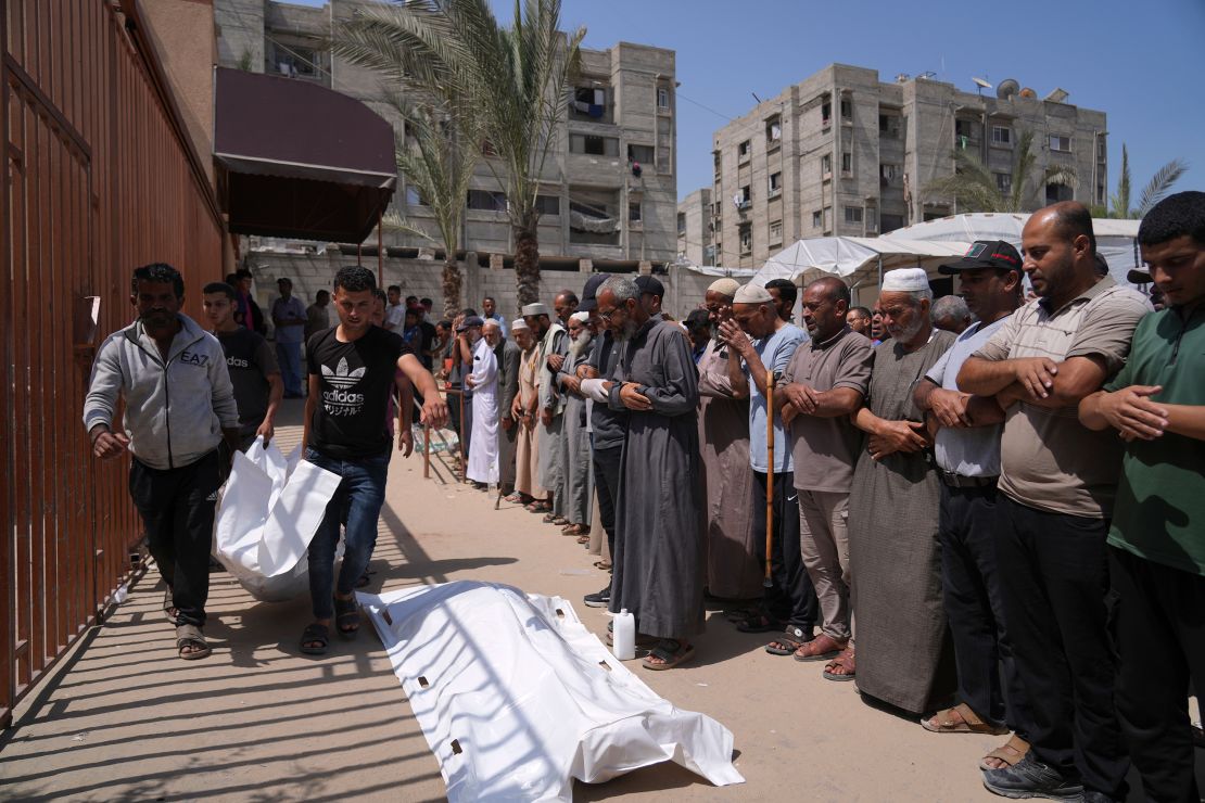The Palestinians pray during the funeral for the people who were killed by heading towards a Gaza Help Center on Sunday.