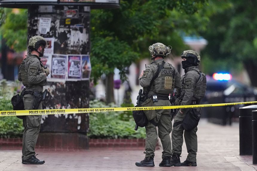 Law enforcement officials investigate after an attack on the Pearl Street Mall, Sunday, June 1, 2025, in Boulder, Colorado.