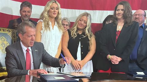 Nebraska Gov. Jim Pillen is flanked by supporters Wednesday, June 4, 2025 as he signs into law a bill banning transgender athletes from girls' sports. (AP Photo/Margery Beck)