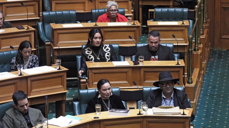 New Zealand lawmakers, Hana-Rāwhiti Maipi-Clarke, center at second row, Debbie Ngarewa-Packer, center in front row, and Rawiri Waititi, bottom right, who received lengthy suspensions from Parliament for a protest haka they performed last November, watch as other legislators debate their proposed bans in Wellington, New Zealand Thursday, on June 5, 2025.
