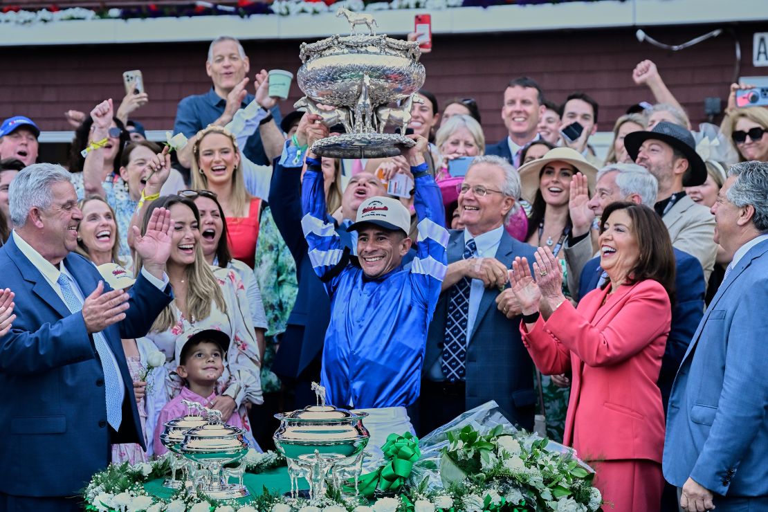 Alvarado celebrates with Sovereignty trainer Bill Mott after the Belmont Stakes.
