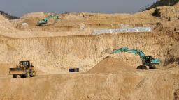 Workers use machinery to dig at a rare earth mine in Ganxian county in central China's Jiangxi province on Dec. 30, 2010.
