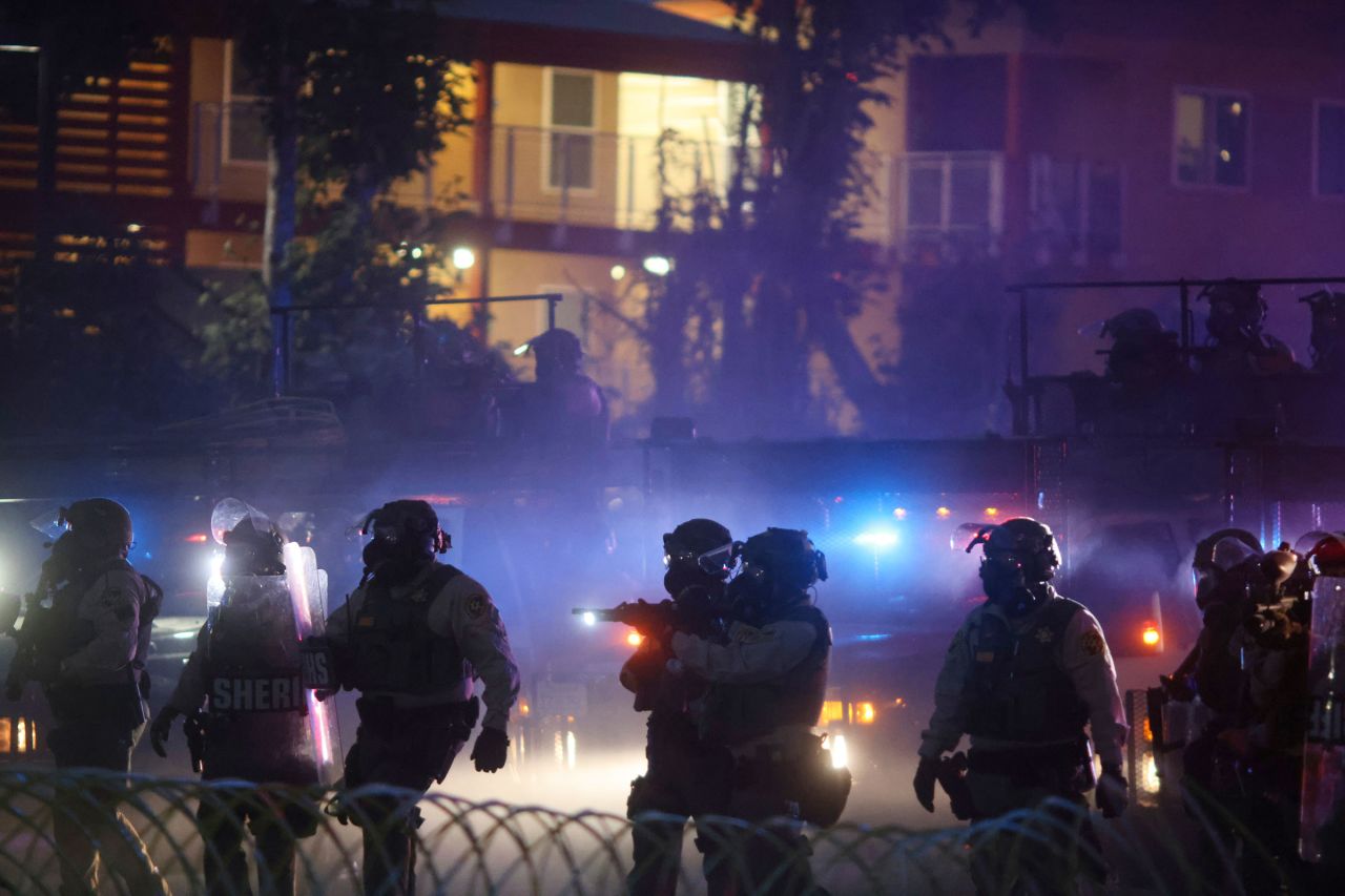 Law enforcement stand during a protest in Compton, California, on Saturday.
